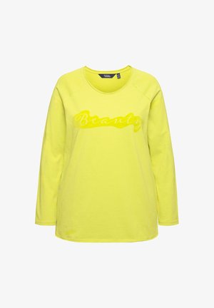 T-shirt à manches longues jaune avec un col rond et des finitions côtelées. Présente le mot "Beauté" en finition brillante sur le devant. Tissu doux.