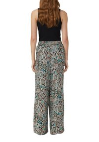 Pantaloni a gamba larga con motivo in nero, beige e teal; cintura elastica; i design geometrici creano texture e interesse visivo; tessuto leggero.