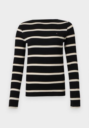 Maglia a maniche lunghe a righe nere e crema con texture a coste e scollo rotondo. Presenta sottili strisce orizzontali alternate.