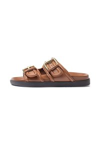 Brown leather slide sandals with two prominent gold-tone buckles, a smooth texture, and a black rubber sole. Designed for casual wear.