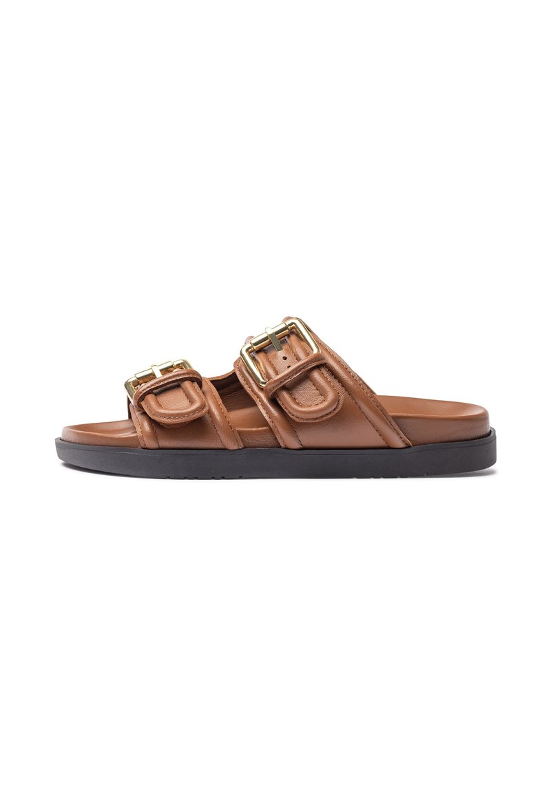 Brown leather slide sandals with two prominent gold-tone buckles, a smooth texture, and a black rubber sole. Designed for casual wear.