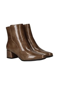 Bottines marron en cuir brillant, avec un design moderne, un bout carré et un talon carré pour plus de stabilité.