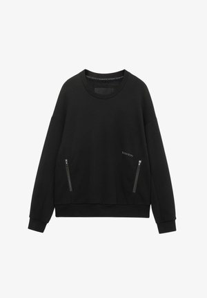 Zwarte sweatshirt met een ronde hals, lange mouwen en zijzakken met rits. Heeft een gestructureerde afwerking en een losse pasvorm.
