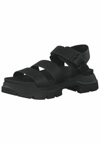 Sandalia negra con múltiples tiras anchas y una hebilla. Presenta una suela gruesa y texturizada con estrías para un mejor agarre. Diseño minimalista.