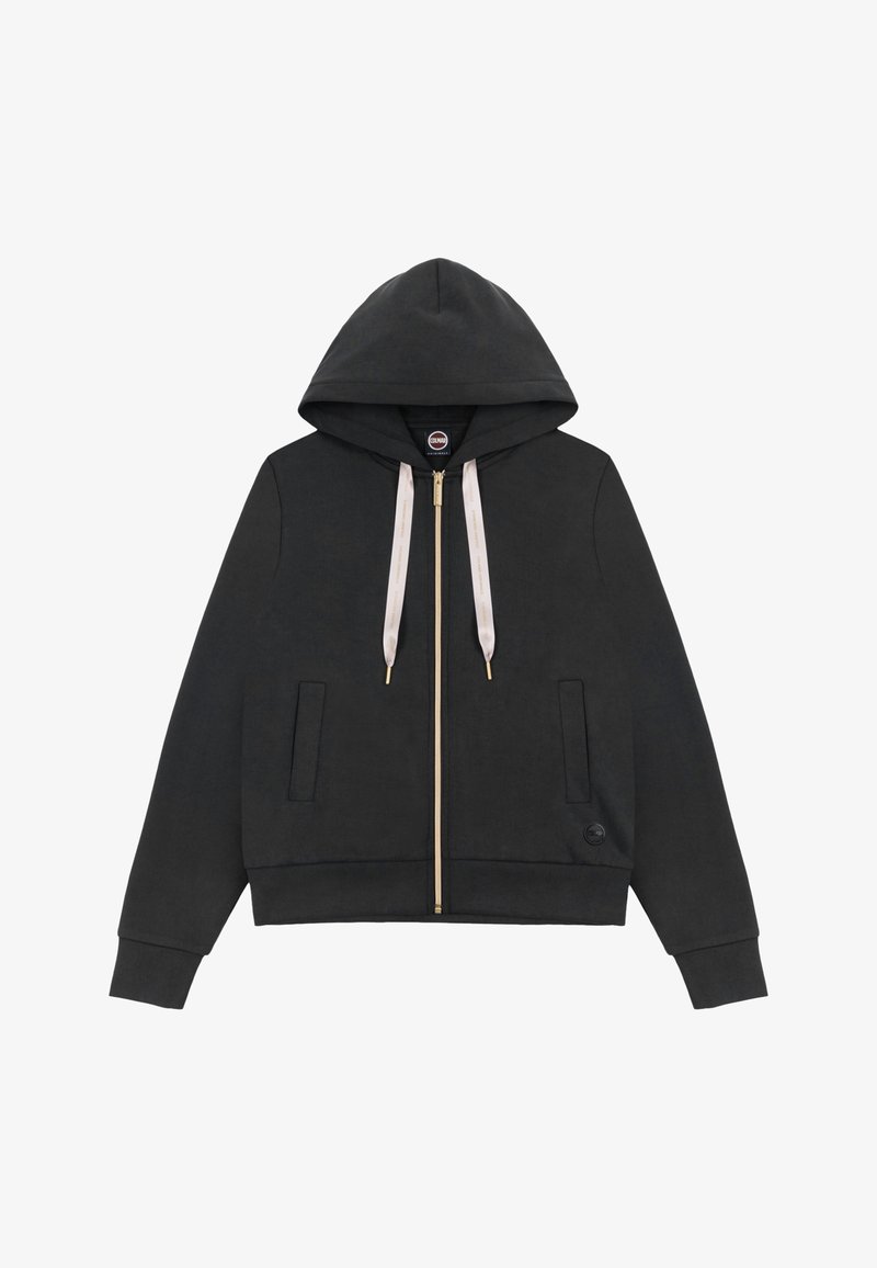 Zwarte hoodie met ritssluiting, beige trekkoorden, twee steekzakken aan de voorkant, geribde manchetten en zoom, en een klein rond logo vlak bij de onderzoom.