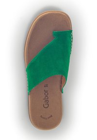 Green suede slide sandal with a wide, curved strap and a flat, brown sole. Features beige stitching along the strap edges. Brand visible.