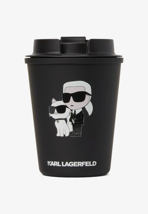 Must mustreuse kauss musta värvi, millel on koomikslik kujundus figuurist ja kassist, kellel on päikeseprillid. Altpoolt valge tekst "KARL LAGERFELD".