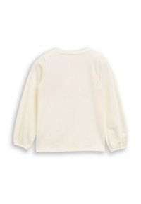 Langemouwen top in crème, gemaakt van zachte stof. Heeft een ronde halslijn en elastische mouwen. Gladde textuur met een ontspannen pasvorm.