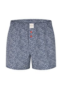 Námořnické modré boxerky s bílým květinovým vzorem, elastickým pasem a dvěma červenými knoflíky na přední straně. Vyrobeno z lehkého materiálu.