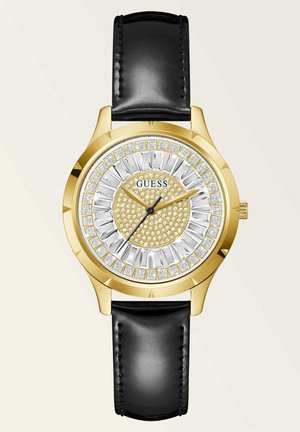 Montre dorée avec un cadran argenté et doré présentant un motif texturé et des accents en cristal ; bracelet en cuir noir.