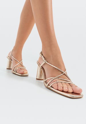 High heeled sandals - gold coloured