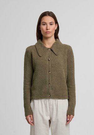 Cardigan verde oliva, testurizzato, con colletto, bottoni frontali e maniche lunghe. Il materiale sembra morbido e accogliente, adatto per essere indossato a strati.