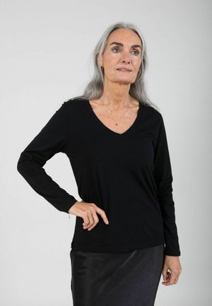 - Bluzka z długim rękawem