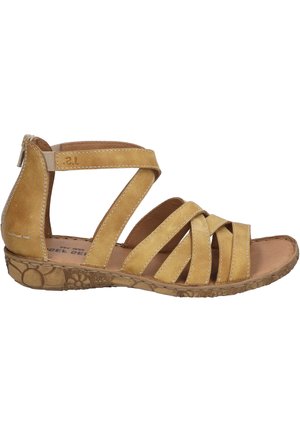 Gelbe Leder-Sandale mit mehreren überkreuzten Riemen, einem niedrigen Absatz und einer strukturierten Gummisohle. Reißverschluss hinten für ein einfaches Anziehen.