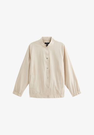 Veste beige clair avec un col montant, fermeture à boutons-pression, poignets élastiques et deux poches latérales. Fabriquée en tissu lisse et texturé.