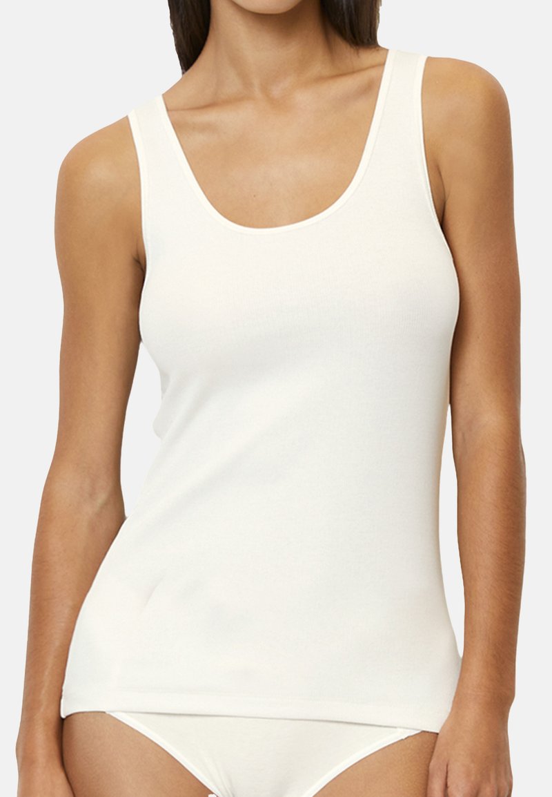 White cotton tank top with a scoop neckline and slim fit. Features smooth texture and lightweight fabric. Ideal for layering or casual wear.