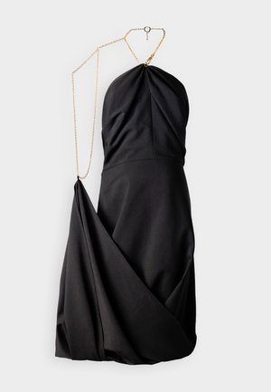 Black dress with a fitted bodice and draped skirt. Features a gold chain shoulder strap, soft fabric, and a smooth texture.