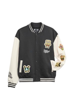 Sort og creme varsity jakke med tegneserie-patcher, ribbede ærmer og krave, forlommer og to-farvede ærmer.