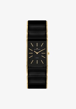 Sort rektangulært keramisk armbåndsur med gyldne markører, visere og kanter, viser klokken 1:10, mærket Jacques Lemans.