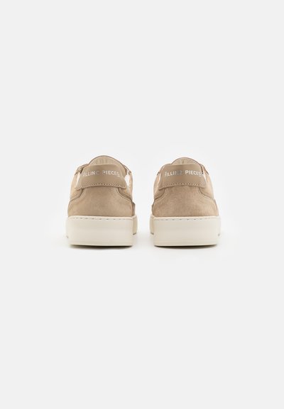 Beige suede sneakers with a round toe, white rubber sole, and a smooth heel cap featuring embossed "FILLING PIECES" branding.