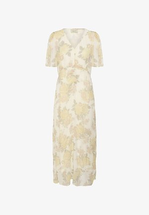 Robe longue couleur crème avec manches courtes, col en V et motif floral jaune sur tout le tissu.