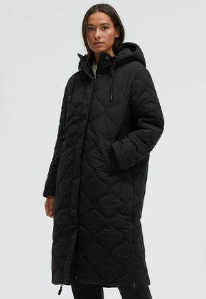 Black quilted long coat with a hood, featuring a diamond pattern, front zipper, and side pockets. The fabric appears smooth and padded.