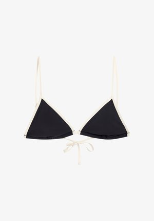 Haut de bikini noir triangle avec bordure blanche et fines bretelles, noué à l'avant avec un nœud en cordelette blanche.