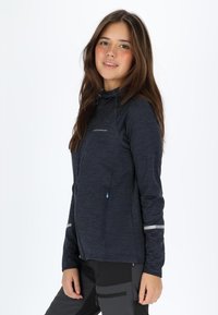Navy blue zip-up jacket with a high collar, gray accents, a side pocket, and a textured fabric. Reflective stripes on sleeves for visibility.