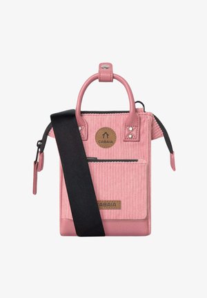 Pink bag with a mix of smooth and corduroy textures, featuring a top handle, adjustable black strap, front pocket, and brand tag.