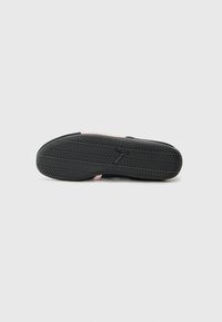 Black rubber sole with textured tread, featuring a pink accent at the heel. The design is flat and wide, suitable for casual wear.