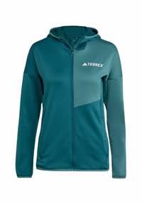 Kapucňová bunda v odtieňu teal, s predným zipsom, textúrovanou tkaninou a kontrastnou svetlejšou časťou s logom Terrex na hrudi.