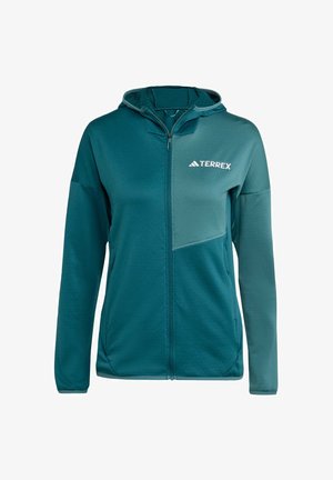 Hupullinen takki turkoosina, jossa on vetoketjullinen etuosa, teksturoitu kangas ja vaaleampi paneeli Terrex-logolla rinnassa.