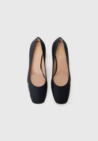 Black high-heel shoes with a smooth finish, rounded toes, and a 'Love Moschino' label on one side, displayed on a light background.