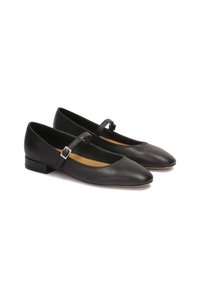 Black leather flats with a rounded toe, a thin strap across the top, and a small block heel. Smooth texture, minimalist design.