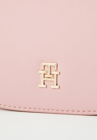 Tommy Hilfiger LOGOTAPE SADDLE BAG - Cross body bag - pink