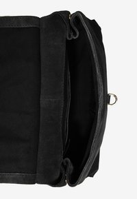 Czarna zamszowa torebka z materiałową podszewką, posiadająca dwie przegrody, zamek błyskawiczny oraz złote akcenty wykończenia.