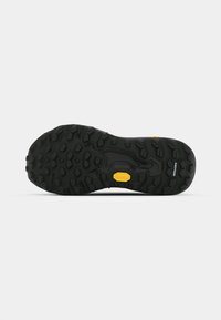 Semelle extérieure en caoutchouc noir avec un motif de semelle texturé pour une meilleure adhérence, accompagnée d'un logo "Vibram" jaune et d'un détail de marque "Megagrip".