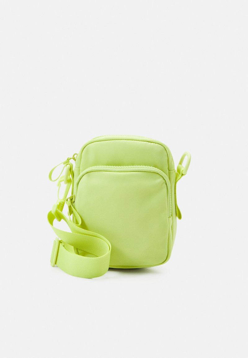 Borsa compatta a tracolla in verde lime brillante, realizzata in nylon liscio. Dotata di scomparto principale con zip e tracolla regolabile.