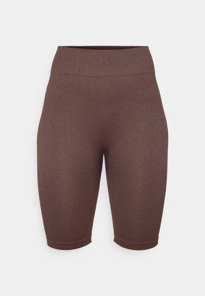 Rjave rebraste kolesarske hlače z visokim pasom, izdelane iz raztegljivega materiala, z gladko teksturo in prilegajočo obliko.