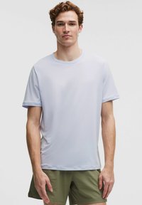 Helderblauw sport T-shirt met korte mouwen van lichtgewicht stof. Het heeft een ronde hals en een gladde textuur met minimale naden.
