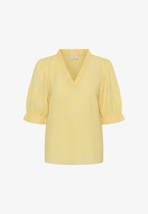 Hele kollakas tekstuuriga pluus, millel on V-kaelusega volangidega krae ja lühikesed volangidega varrukad, mis lõpevad volangiliste mansettidega.