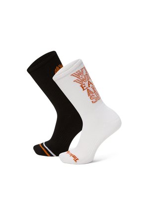 Jeden czarny i jeden biały skarpetka załogowa z pomarańczowo-białym paskowanym czubkiem, pomarańczowym wzorem tekstowym na białej skarpecie oraz pomarańczowym logo na palcach.