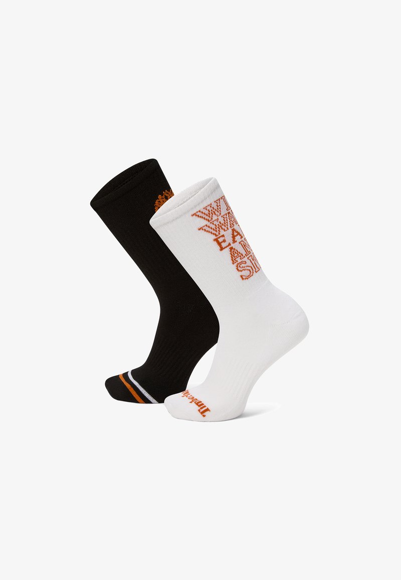 Une chaussette basse noire et une blanche avec un bout rayé orange et blanc, un motif de texte orange sur la chaussette blanche, et un logo orange sur les orteils.