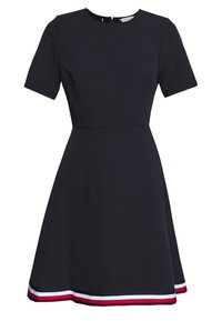 Marine A-lijn jurk met korte mouwen, ronde halslijn en een uitlopende rok. Heeft een driekleurige gestreepte onderrand in rood, wit en blauw.
