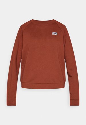 Mikina barvy rezavé s dlouhými raglánovými rukávy, kulatým výstřihem a malou nášivkou s logem na hrudi. Měkká látka, ležérní střih.