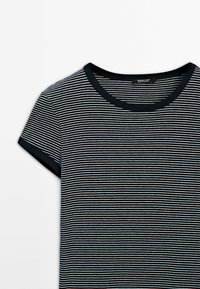Striped t-shirt with a round neckline, featuring black and white horizontal stripes, short sleeves, and a contrasting black trim.