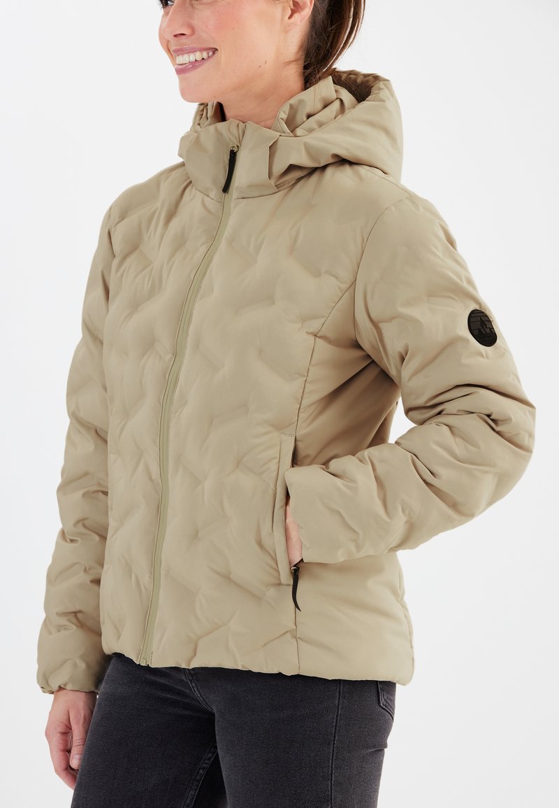 Beige quiltad jacka med huva, som har en frontdragkedja, sidofickor och en rund applikation på vänster ärm. Slät, lättviktsmaterial.
