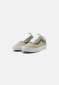 Suede sneakers in olive green with white laces and contrasting black side stripe. Features a rounded toe and white rubber sole.