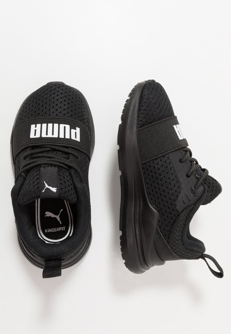 Black athletic shoes with mesh upper, padded collar, and rubber sole. Features a wide strap with "PUMA" logo and lightweight design.