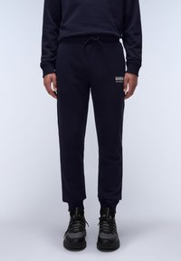 Navyblauwe sweatpants van zacht katoen met een elastische tailleband en een trekkoord, voorzien van een klein logo-opdruk op de linkerdij.